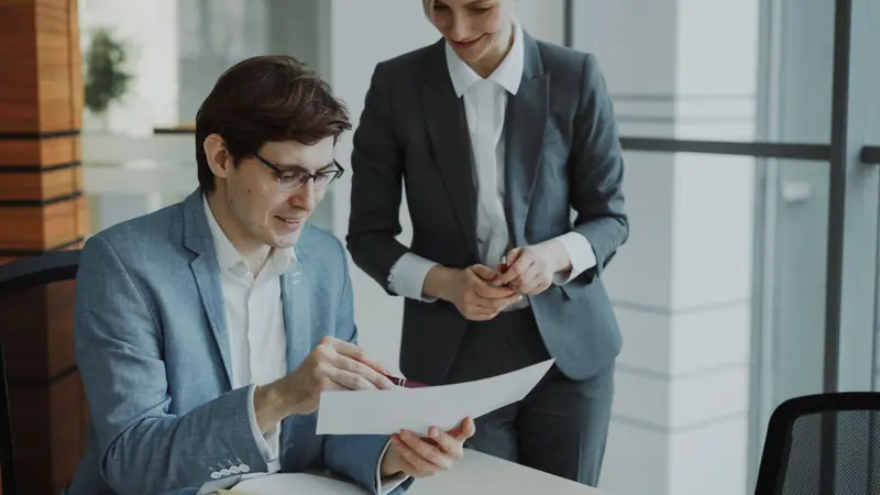 Adviser helping a client with trade paperwork